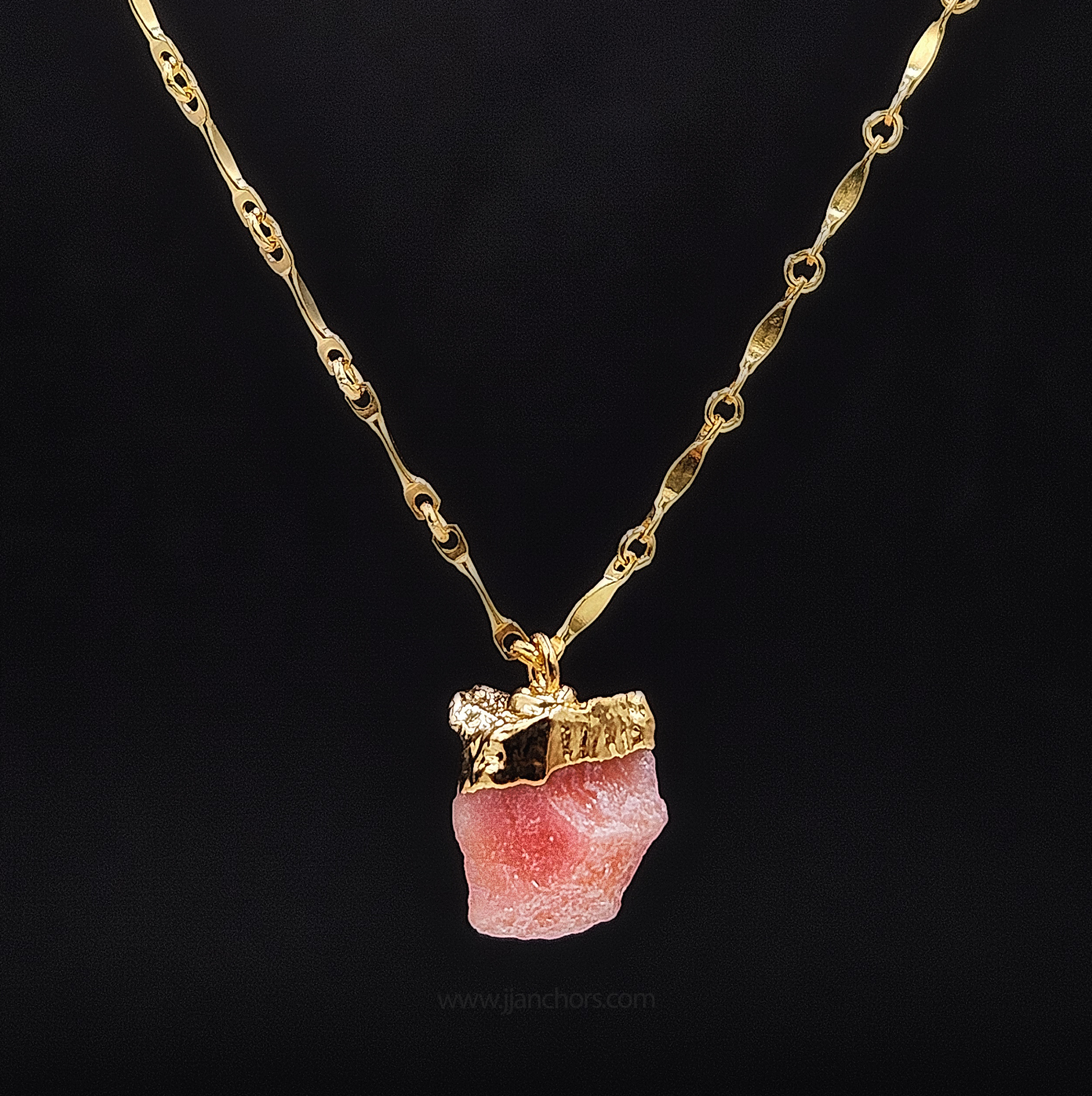 A gold-colored 14K gold-filled dapped bar chain necklace with a natural untreated pink opal pendant.