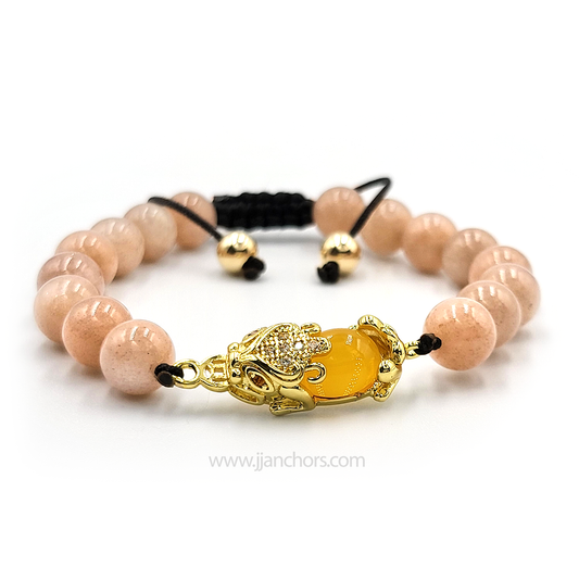 An adjustable bracelet with a mix of citrine and sunstone beads, Pi Yao talisman in the center, and a black silk cord.